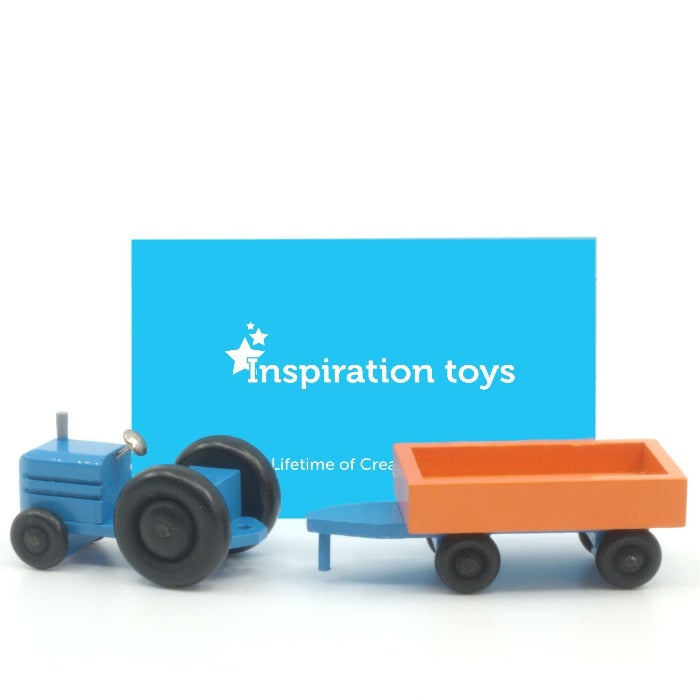 Wooden toy tractor blue and orange trailer disconnected.